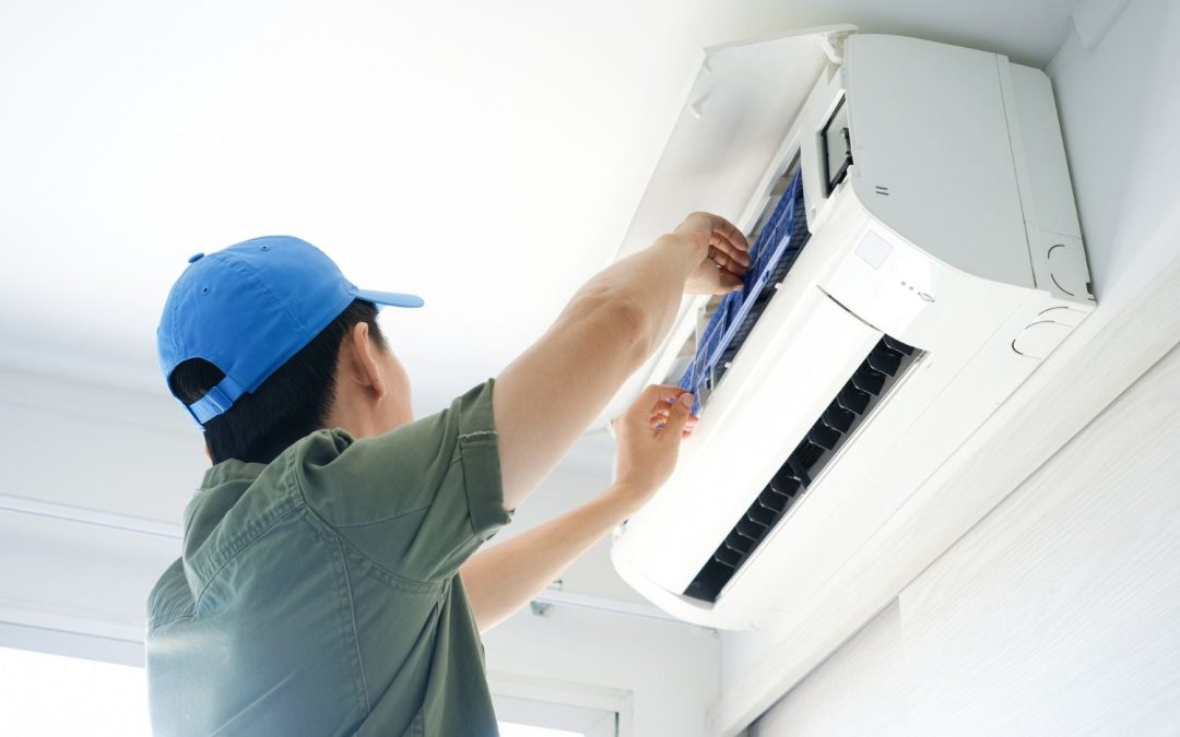 Air conditioning technician maintaining an indoor mini split system in Kaysville, UT